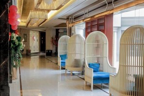 A hotel lobby with a modern design, featuring a long corridor with seating areas and a large window. - Bonway International Hotel (Shiyan)