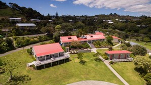 A residential area with houses, a red-roofed building, and a well-maintained lawn. - Russell Top 10 Holiday Villas (Russell)