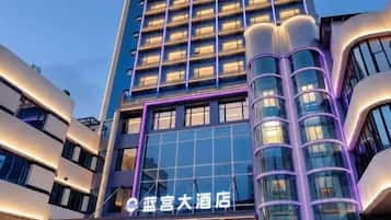A modern hotel building with a prominent sign.