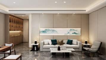 A modern living room with a sofa, coffee table, and side tables.