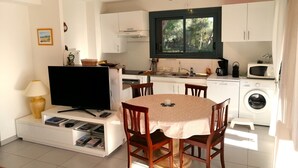 En kompakt bolig med spiseplads, tekøkken og vaskefaciliteter.
