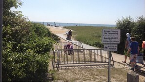 A beach path with a sign indicating beach closure from 11:00 pm to 5:00 am and no dogs allowed. - Quintessential Family Memory Cape Cod Home 1/3 walk to private association beach (East Falmouth)
