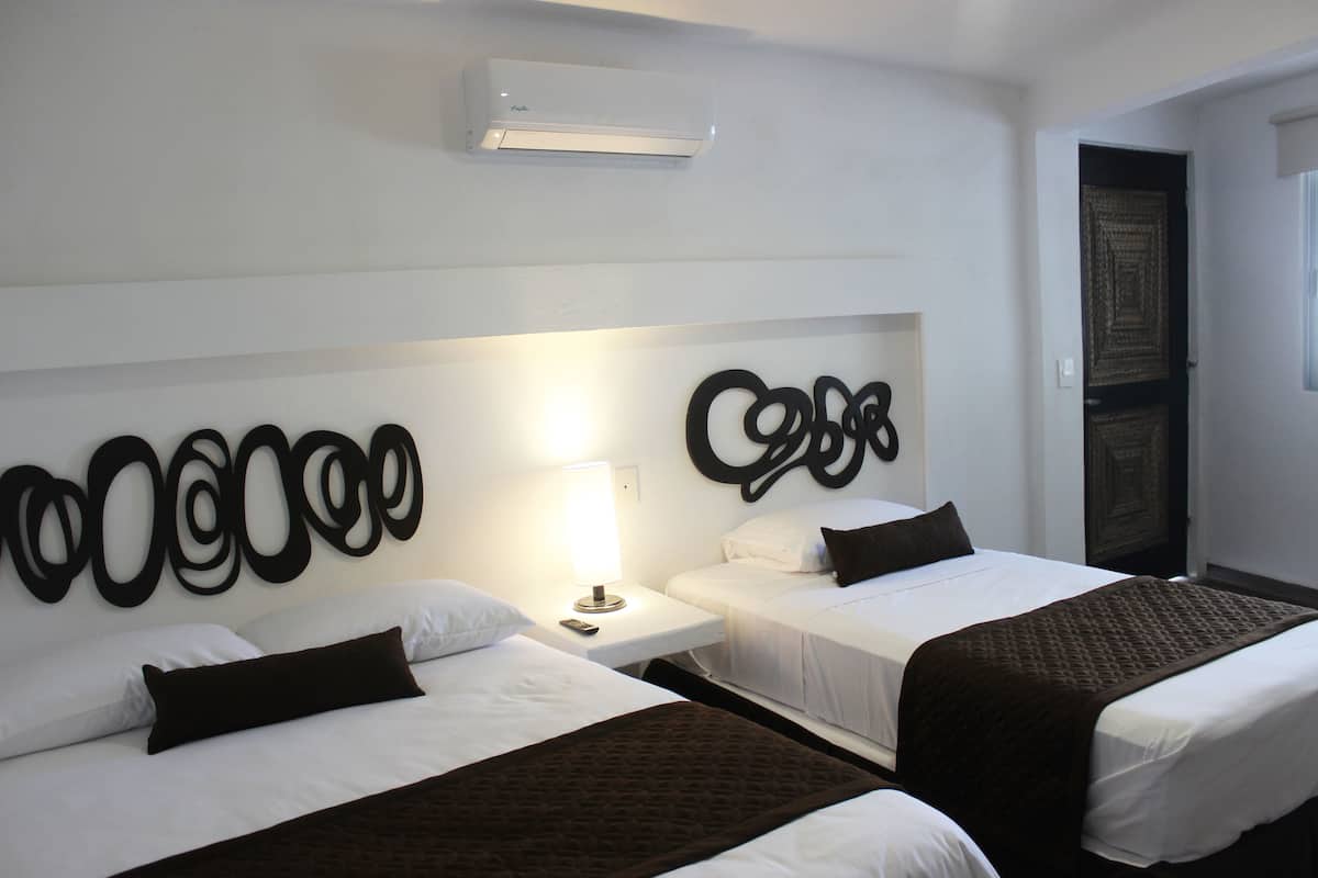 Deluxe Room, Multiple Beds, Non Smoking | In-room safe, WiFi (free), bed sheets