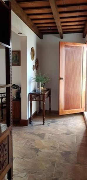 Stunning hallway with a door, table, and framed picture.
