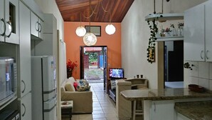 A kitchen with a dining area, a TV, and a view of the outdoors.