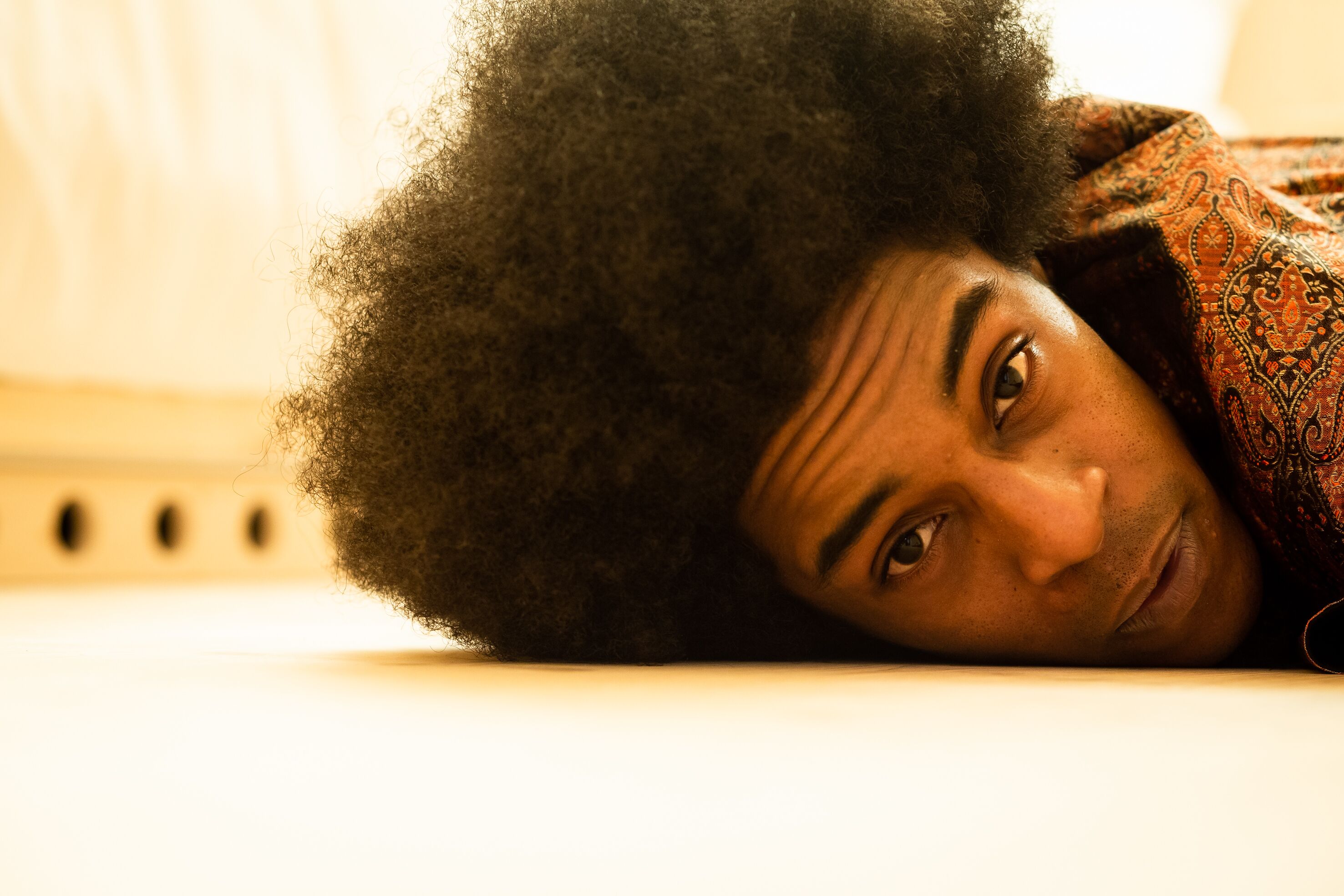 A person lying down with a patterned garment.