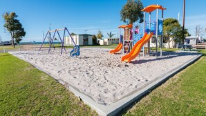 A playground with swings, slides, and climbing structures.