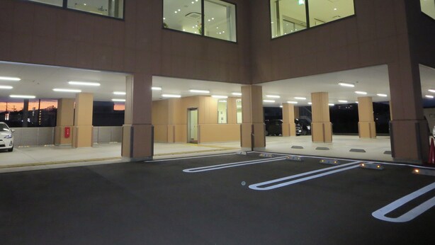 A multi-level parking structure with illuminated ceilings and large windows. - Kesennuma Park Hotel - Adults Only (Kesennuma)