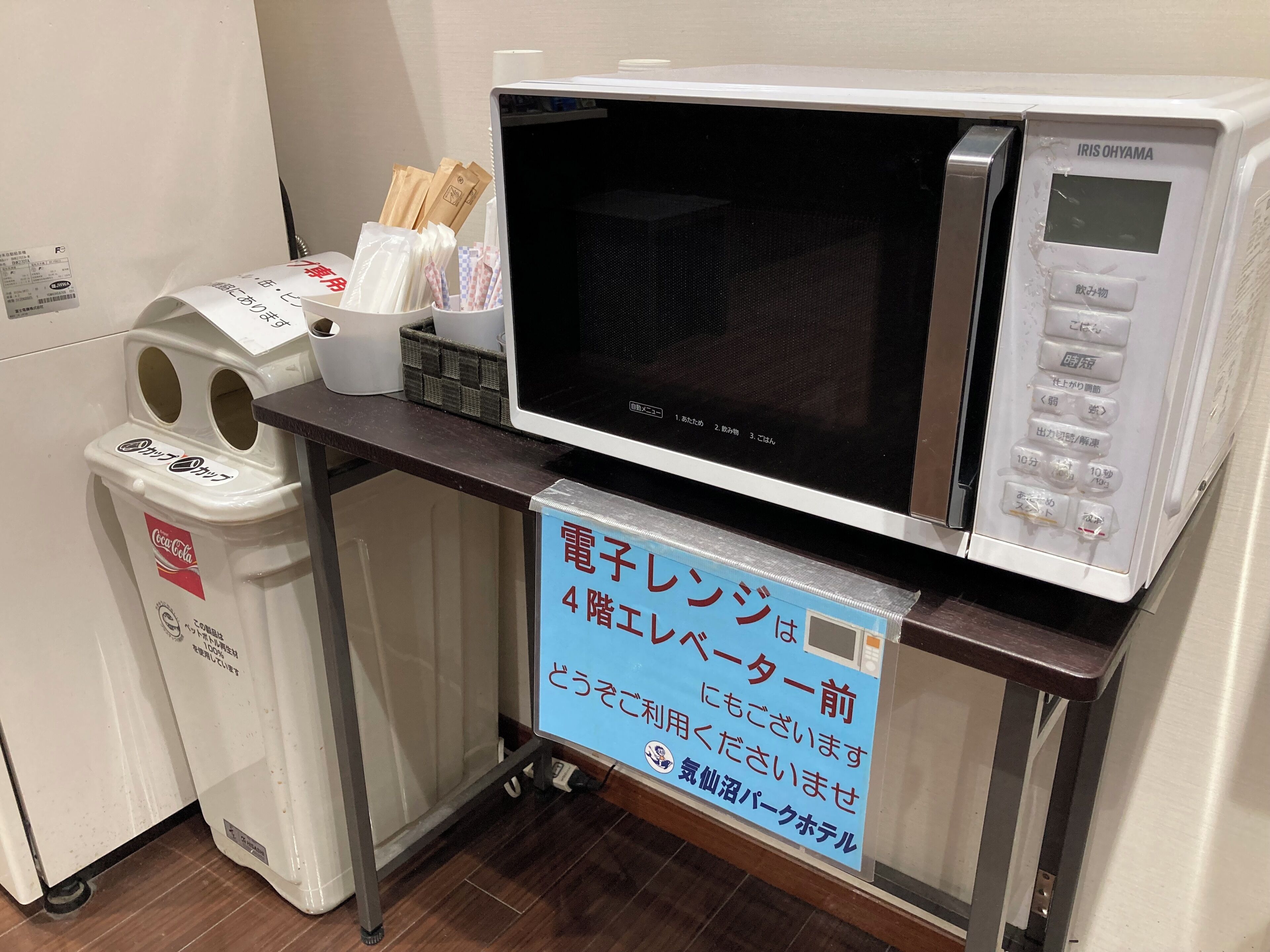 Un four à micro-ondes posé sur un comptoir, avec une pancarte indiquant qu’il s’agit d’un réfrigérateur électrique situé au quatrième étage.