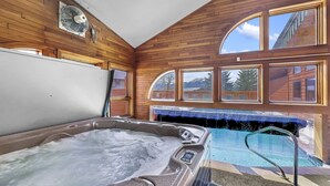 Ein Whirlpool mit Blick auf einen Berg und einen Poolbereich.