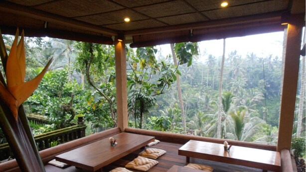A room with wooden tables and benches, large windows with a view of a tropical landscape. - Beautiful Property in Tegalalang Rice terrace (Bali)
