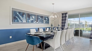 Enjoy meals with family and friends at this spacious dining table for six, surrounded by beautiful artwork and a stunning view.