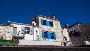 A two-story stone building with blue shutters, a satellite dish, and a 'For Sale' sign. - A seafront, one bedroom apartment with big terrace - Umag Center 1 (Umag)