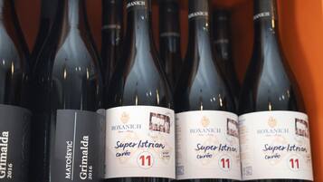 A row of wine bottles with labels indicating 'Roxanich Super Istrian cuvée' and 'Grimalda 2016'.