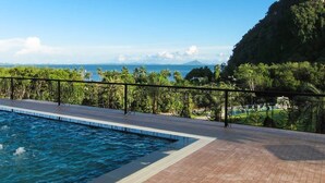 A swimming pool with a view of the ocean and a mountainous landscape. - Apartment in Aonang & Railay Sea View (Krabi)