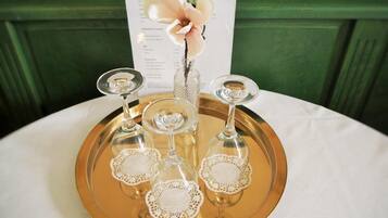 A tray with four wine glasses and a menu on a table.