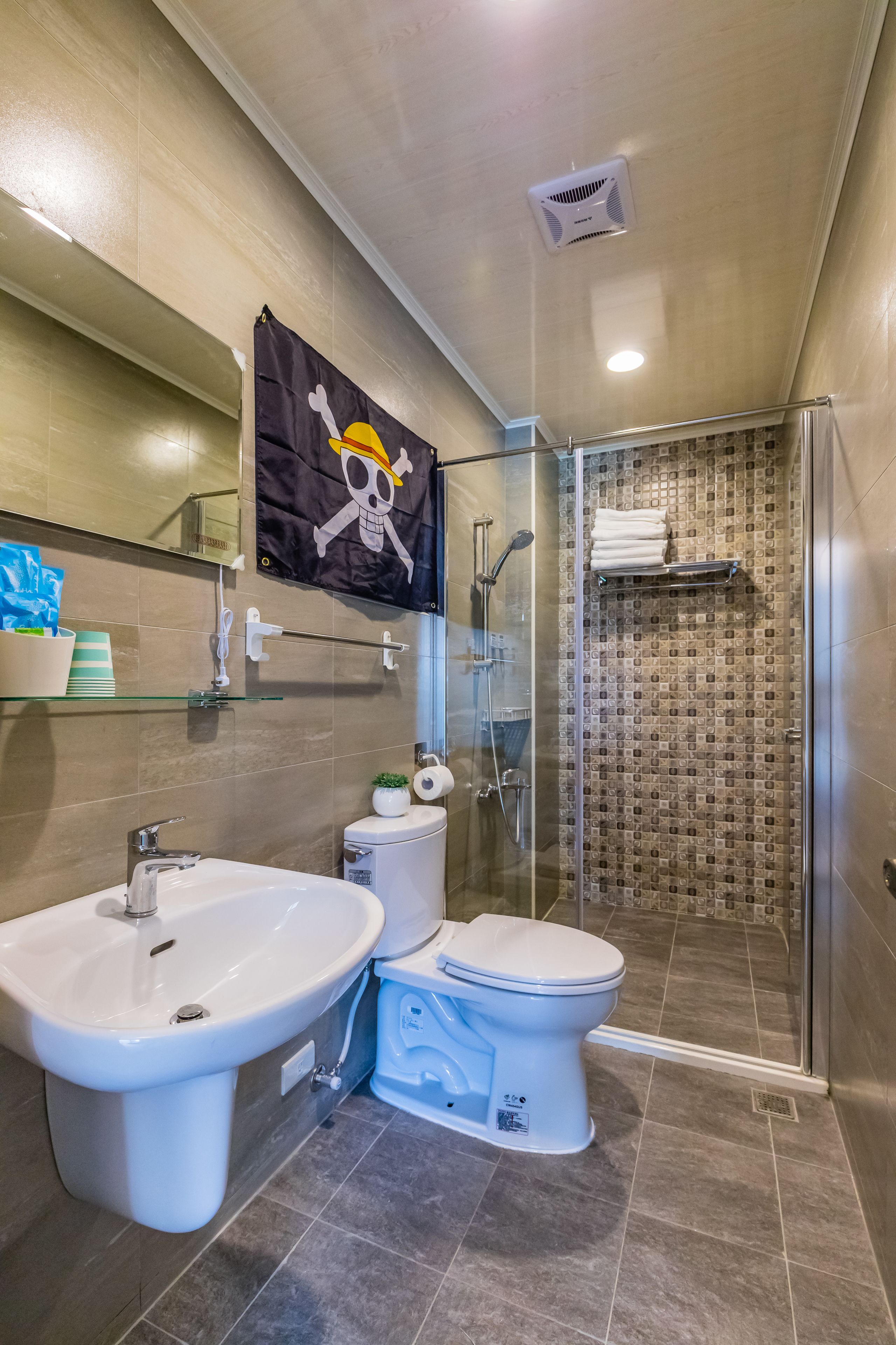 A bathroom with a shower, a toilet, and a bidet.