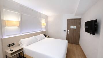 Family Quadruple Room | Minibar, in-room safe, desk, laptop workspace