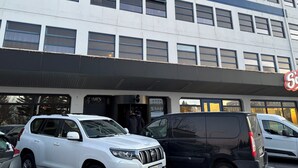 A multi-story building with a blue stripe, large windows, and a sign with a red 'S' logo. - Urban Reykjavik Studios (Reykjavik)