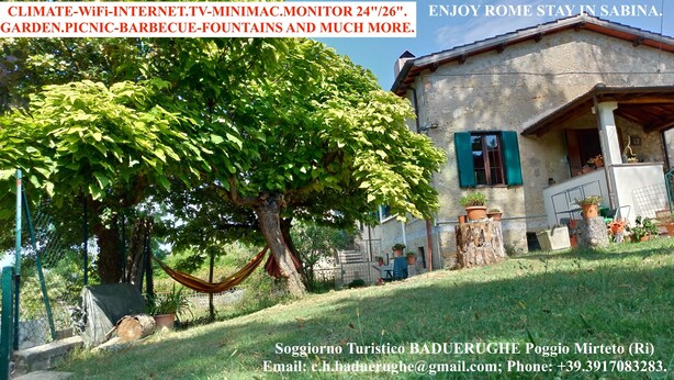 A rustic house with a garden, a hammock, and outdoor furniture. - Baduerughe (Poggio Mirteto)
