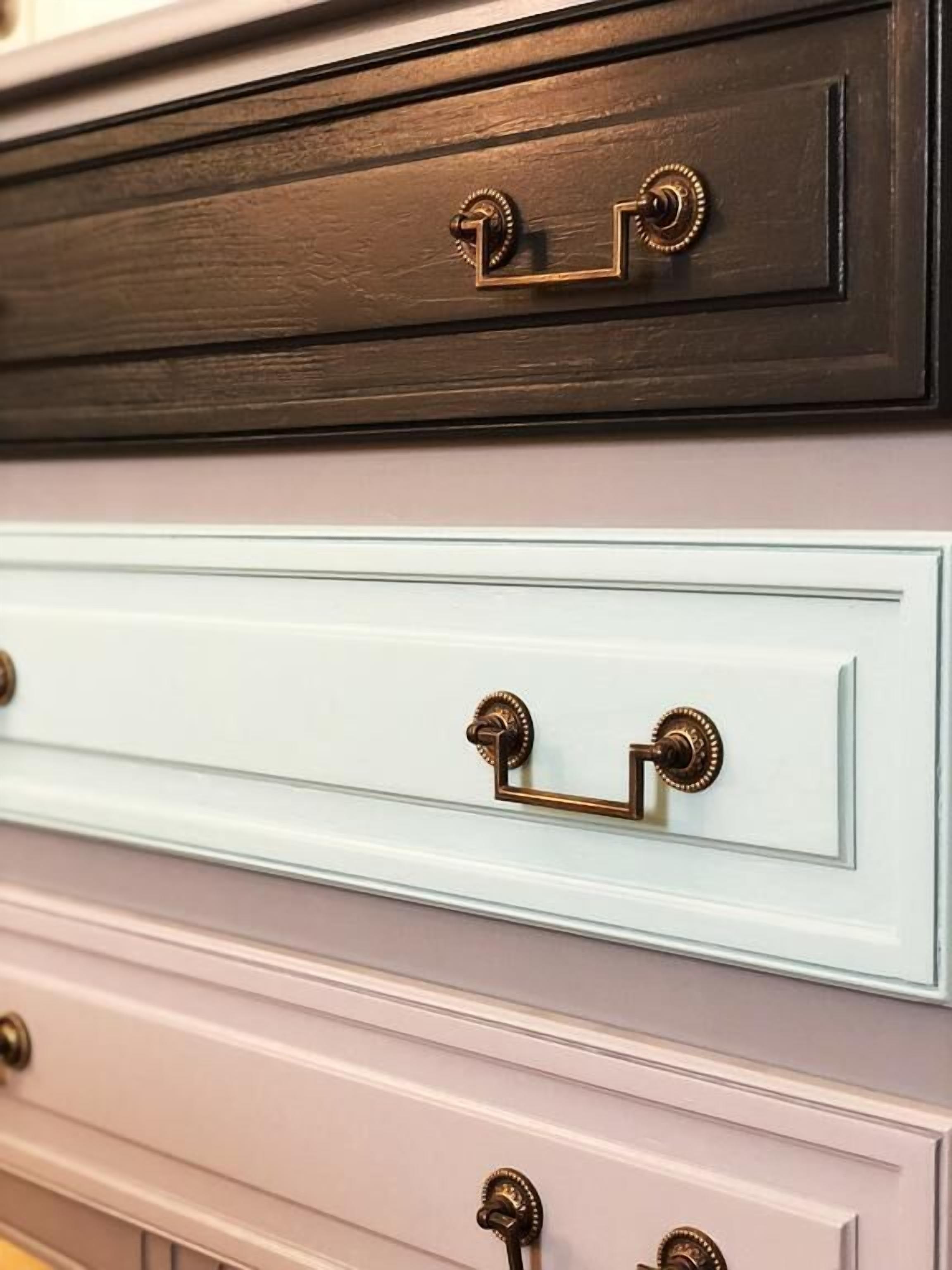 A set of drawers with brass handles.