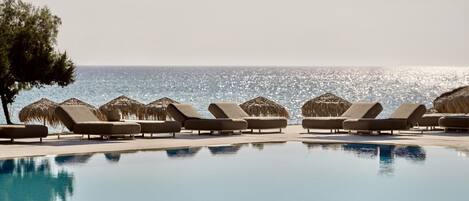 Piscine extérieure, parasols de plage, chaises longues