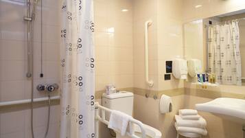 A modern bathroom with a shower, toilet, and sink.