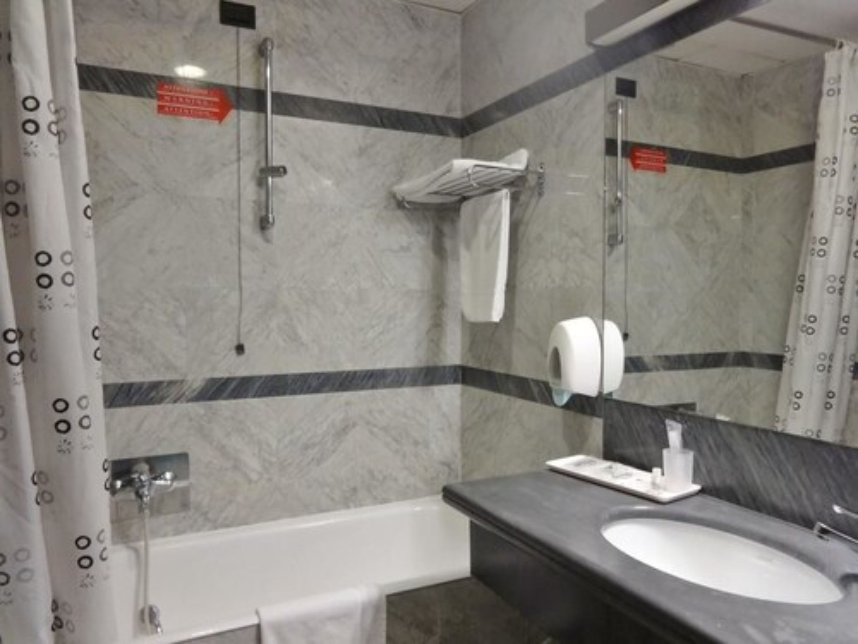 A bathroom with a bathtub, a sink, and a shower.