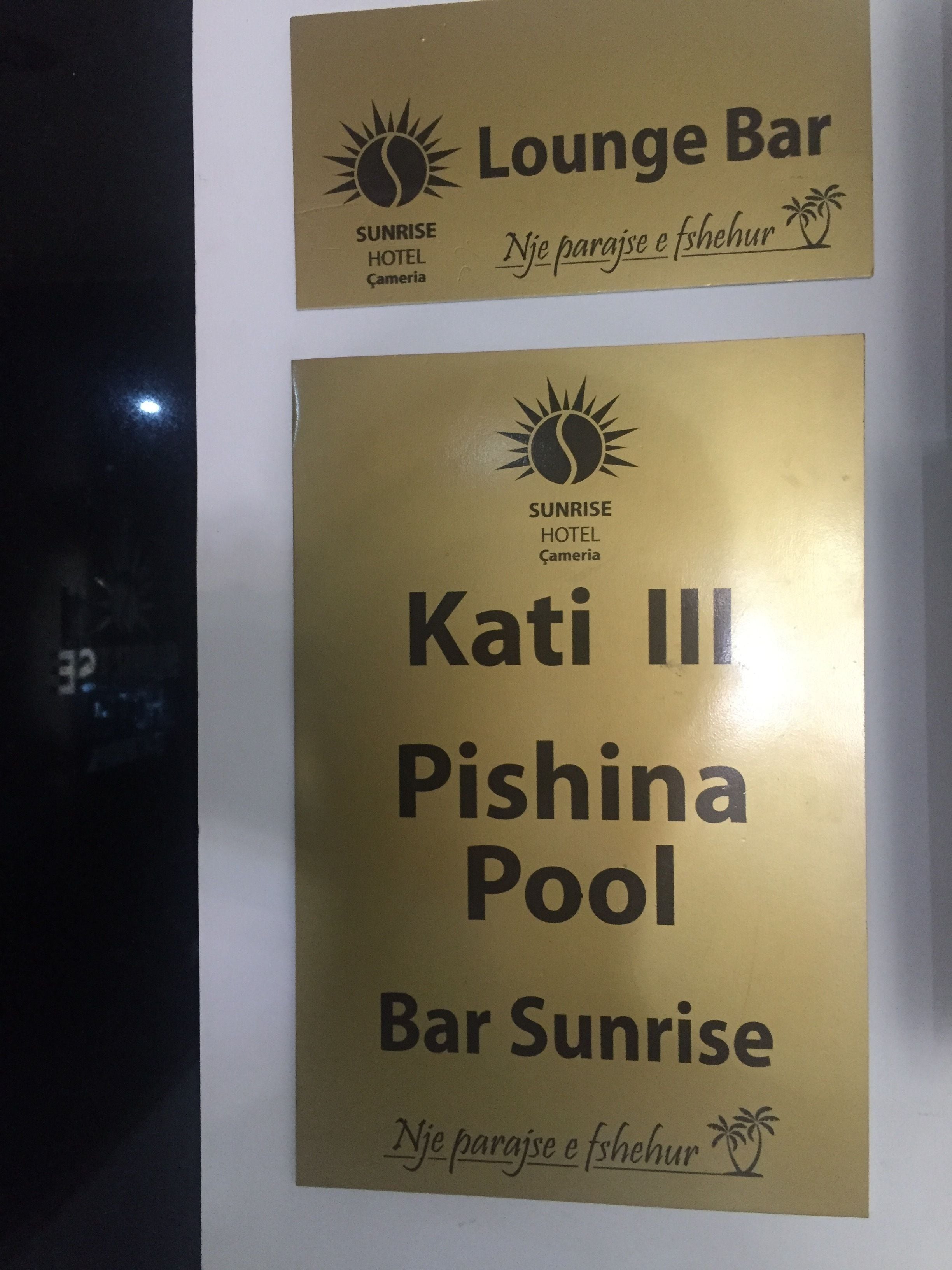 Two signs for Sunrise Hotel's Lounge Bar and Pishina Pool Bar.