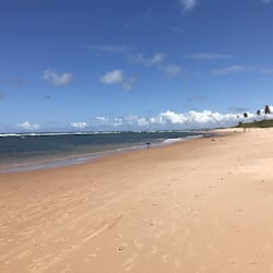 On the beach, white sand, beach umbrellas, beach towels