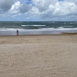 On the beach, white sand, beach umbrellas, beach towels