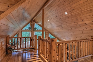 Enjoy the view from the balcony with a potted plant and a glimpse of the surrounding landscape.