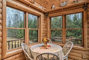 Enjoy meals with friends and family at the large dining table, surrounded by the serene beauty of the forest.