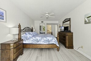 Relaxing primary bedroom with coastal touches and ensuite bathroom access