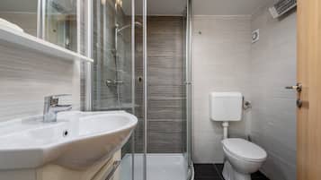 Shower, hair dryer, towels, toilet paper