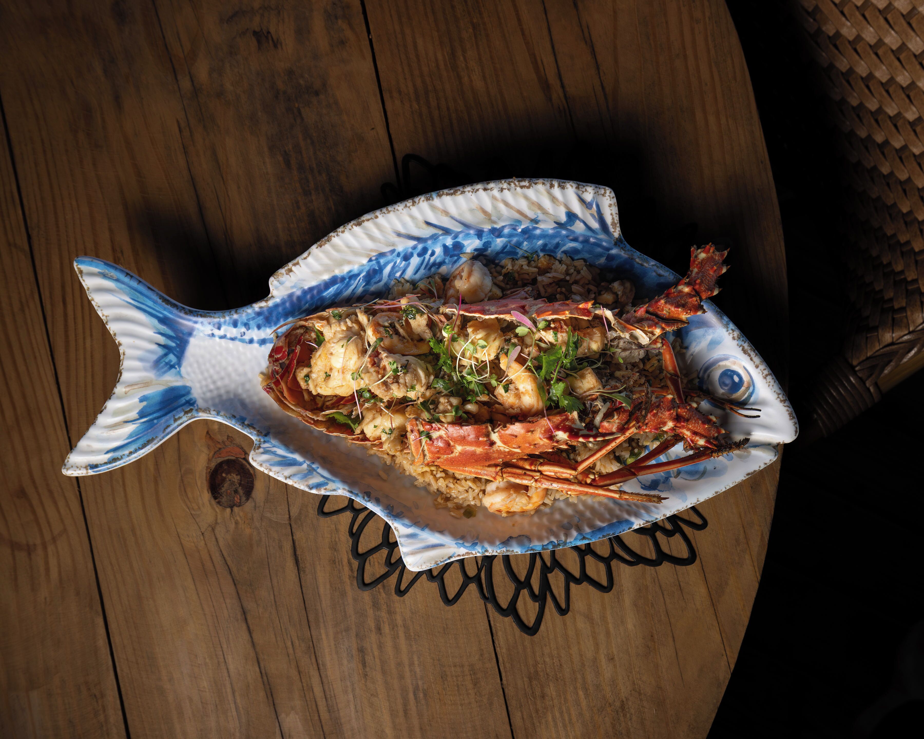A seafood dish on a fish-shaped plate.