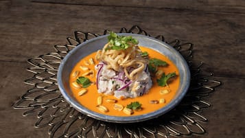 A bowl of food on a metal stand.