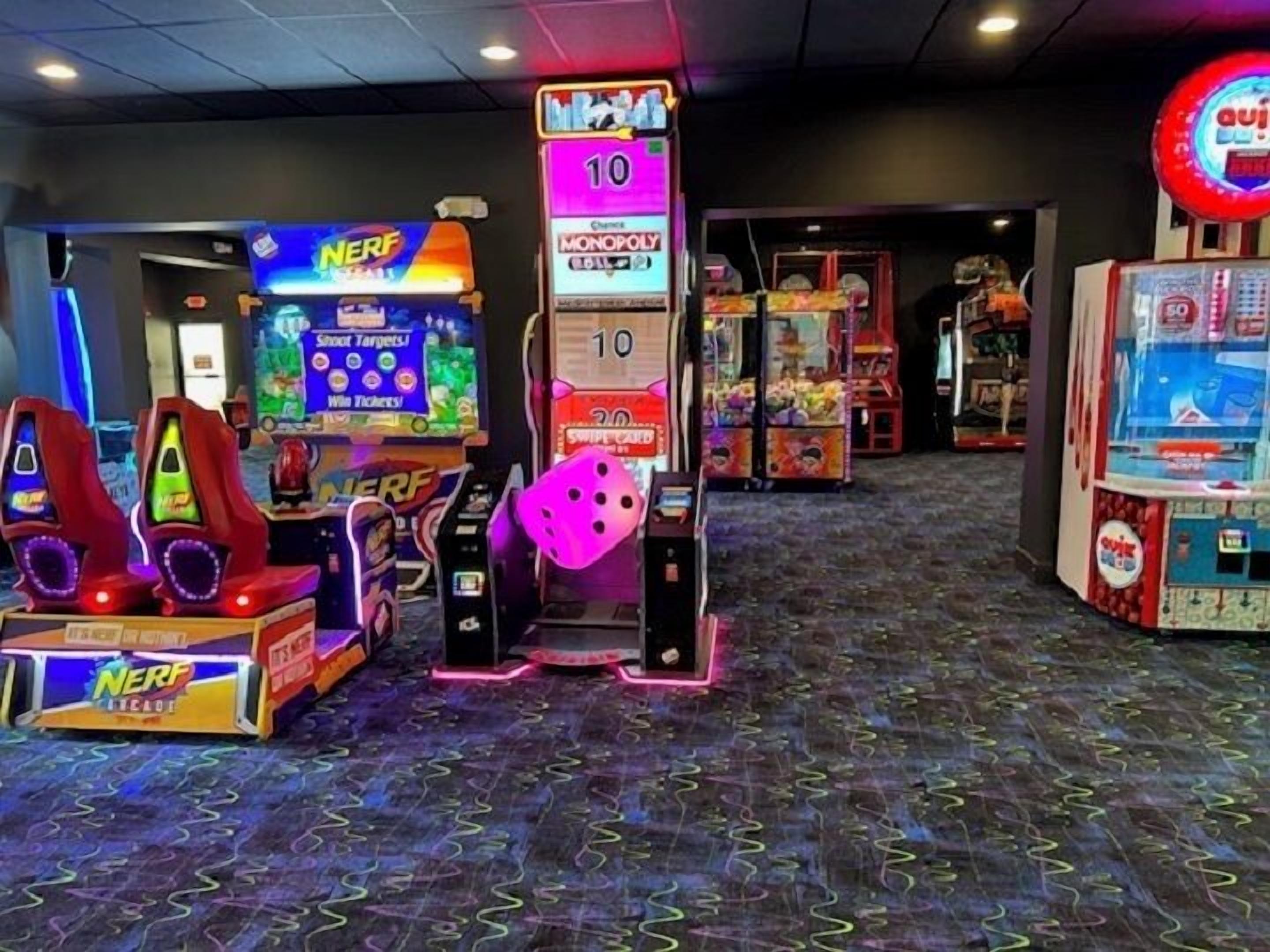 A gaming arcade with various machines including a 'Shoot Targets' game and a 'Monopoly' game.