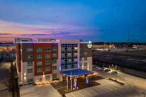 A Holiday Inn Express building with a large parking lot and a covered entrance. - Holiday Inn Express & Suites Houston - Memorial City Centre by IHG (Houston)