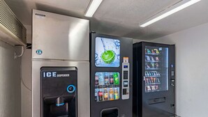 A vending machine with a lime slice graphic, an ice dispenser, and a drink selection panel. - Studio 6 Little Rock, AR - West (Little Rock)