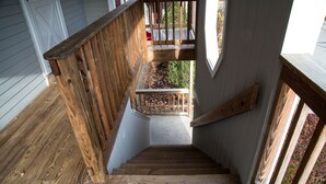 A wooden staircase with a handrail leading to a balcony. - Sunny Condo w/ Outlet Shops, Expansive Mountain, Valley Views Near North Conway (Intervale)