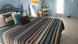 A bedroom with a bed, a ceiling fan, a dresser, a mirror, and a door. - Fantastic Vacation House on Private Lake in Fort Lauderdale (Fort Lauderdale)