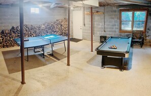 Enjoy a game of pool or ping pong in this room featuring a pool table and ping pong table.