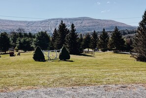 Surrounded by lush trees and a beautifully manicured lawn, this serene setting offers a peaceful escape.