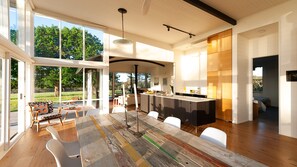 A spacious modern kitchen with a large island, ample natural light, and a view of the outdoors.