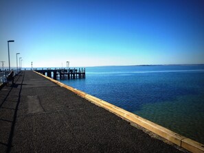 A pier extending into calm waters with a clear sky. - Unit 2-83 Thompson Avenue, Cowes, Spacious 2 bedroom Unit, includes linen. (Cowes)