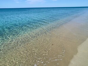 A beach with clear shallow waters and a sandy shore. -  Beachfront Villa with spacious garden and direct beach access  (San Sostene Marina)