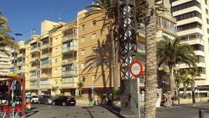 A multi-story building with balconies, palm trees, and a no parking sign. - Front Line 4th floor La Goleta Apt Overlooking Benidorm Island And Levante Beach (Benidorm)