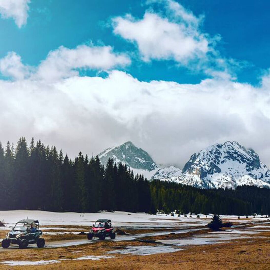 A snowy landscape with mountains and a clear sky.