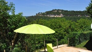 A pool area with a clear view of a hill in the background. - magnificient 16th century MANOR HOUSE with POOL and JACUZZI (Cénac-Et-Saint-Julien)